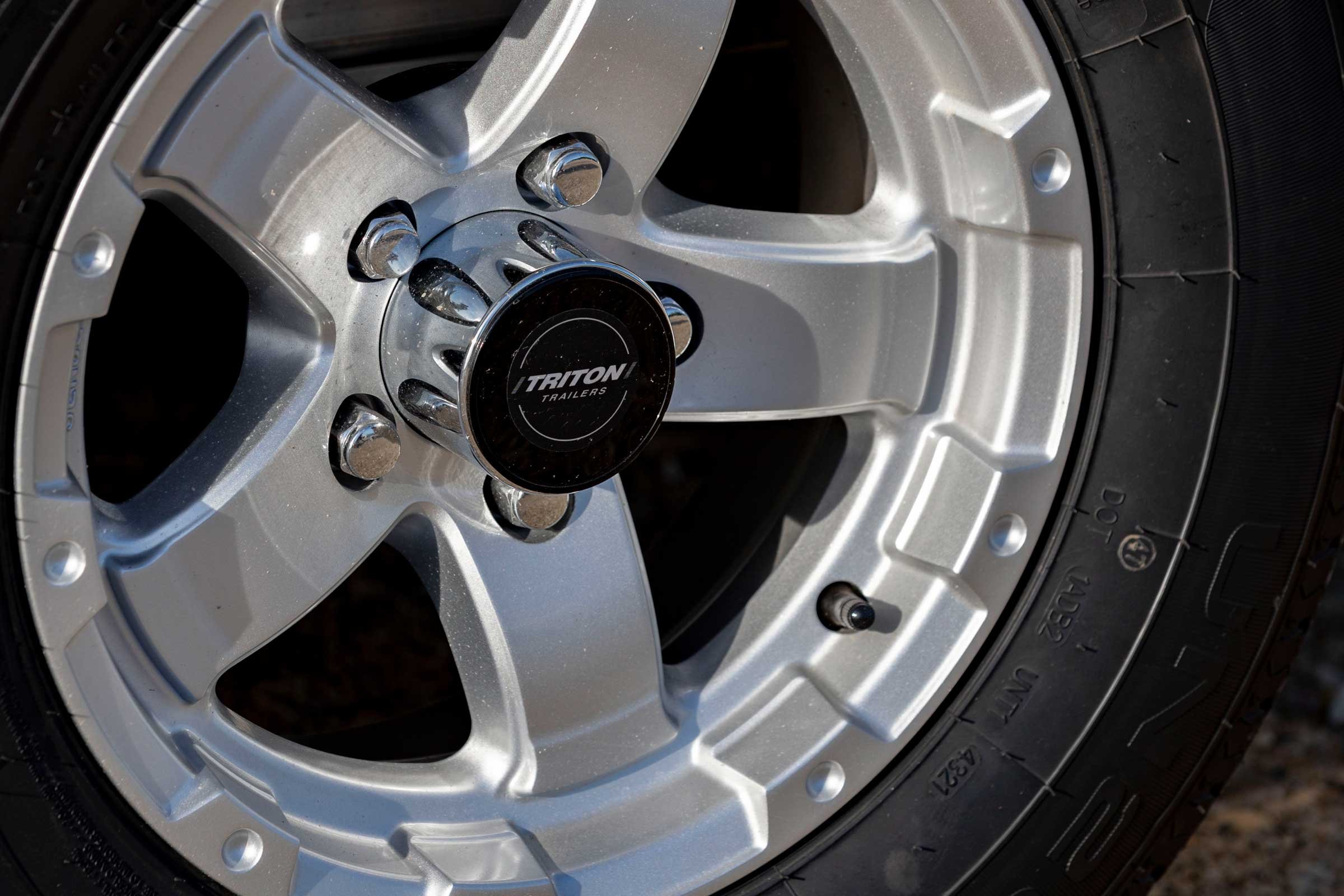 Close up view of an ATV tire with the TIN visible in the lower right corner of the photo on tire's sidewall