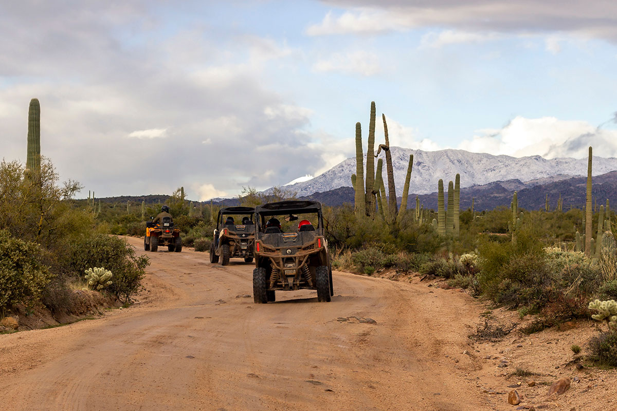 Side by sides driving on a dirt track in the Arizona desert