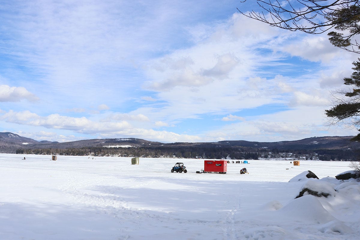 Ice fishing shacks on a frozen New England lake