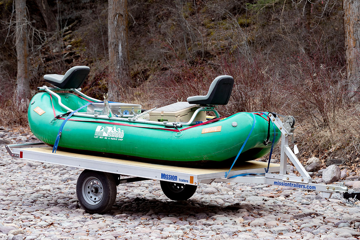 All welded aluminum raft trailer by ALCOM with a whitewater raft loaded and secured.