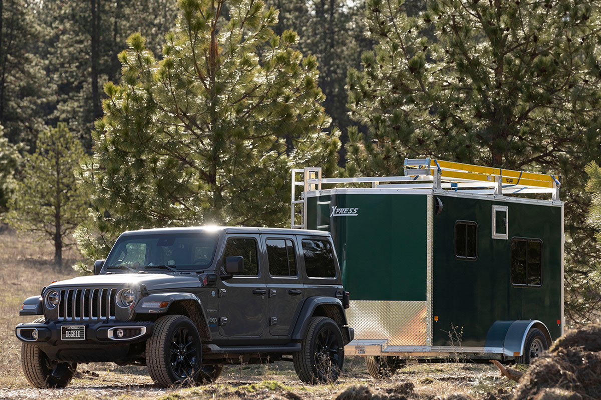 Aluminum Ultimate Contractor Package trailer by ALCOM parked outside behind a Jeep