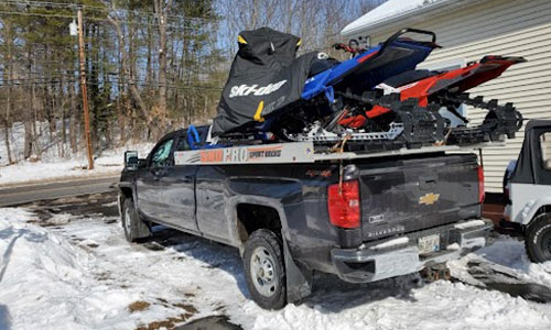 Pickup truck with ALCOM sport deck loaded with two snowmobiles