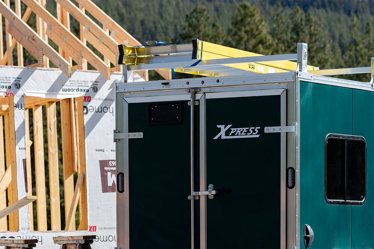 ALCOM green aluminum contractor trailer with double barn doors and ladder rack