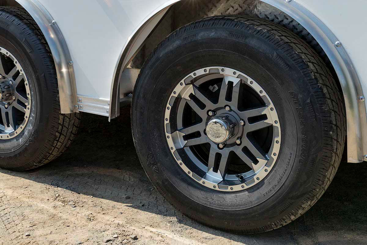 Close up view of ALCOM aluminum trailer premium wheels.