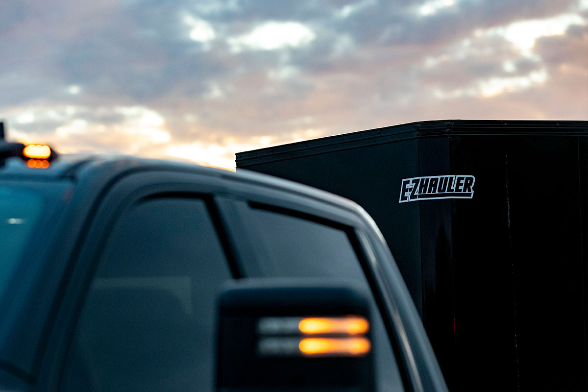 Close up shot of the V-nose of an EZ Hauler enclosed aluminum cargo trailer showing EZ Hauler logo.