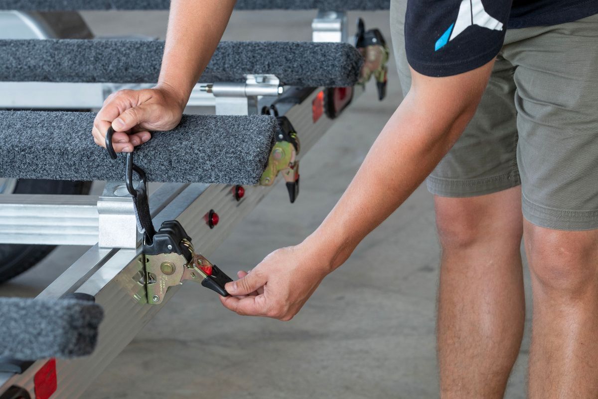 BUnks and ratchet straps on aluminum PWC trailer