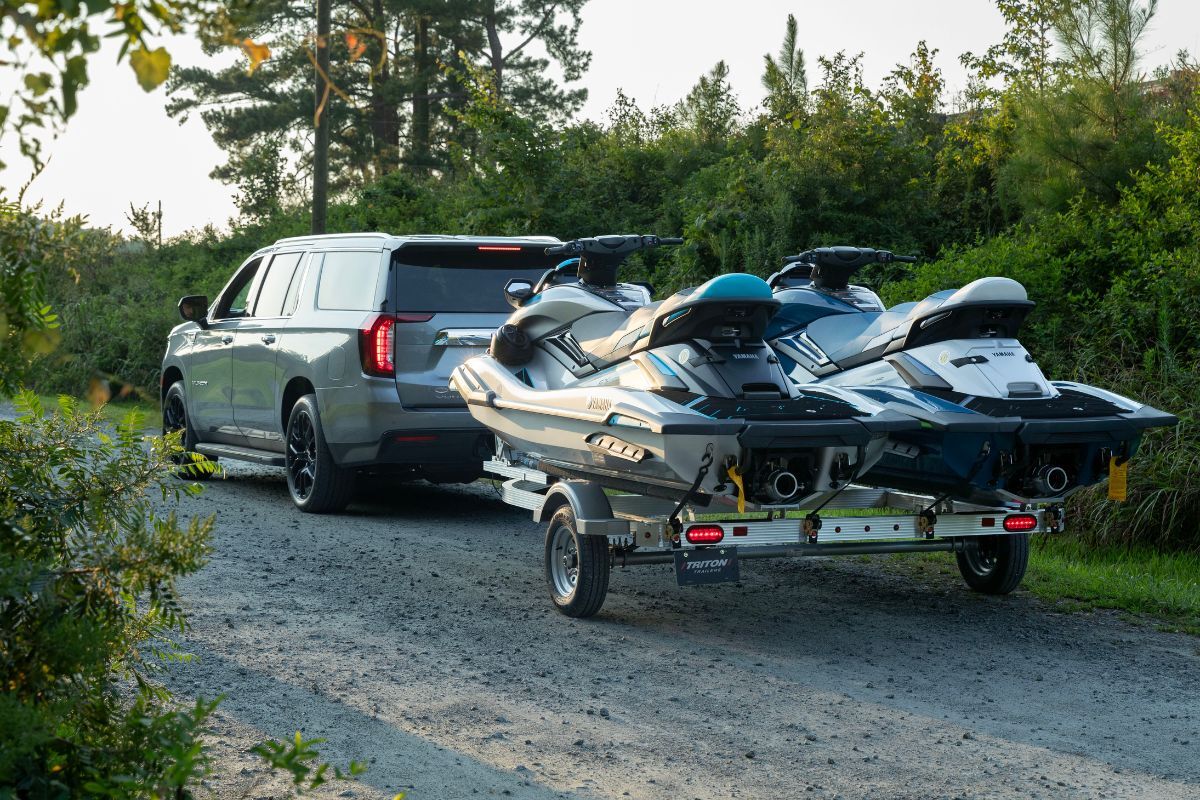 Gray SUV with 2 place PWC trailer parked