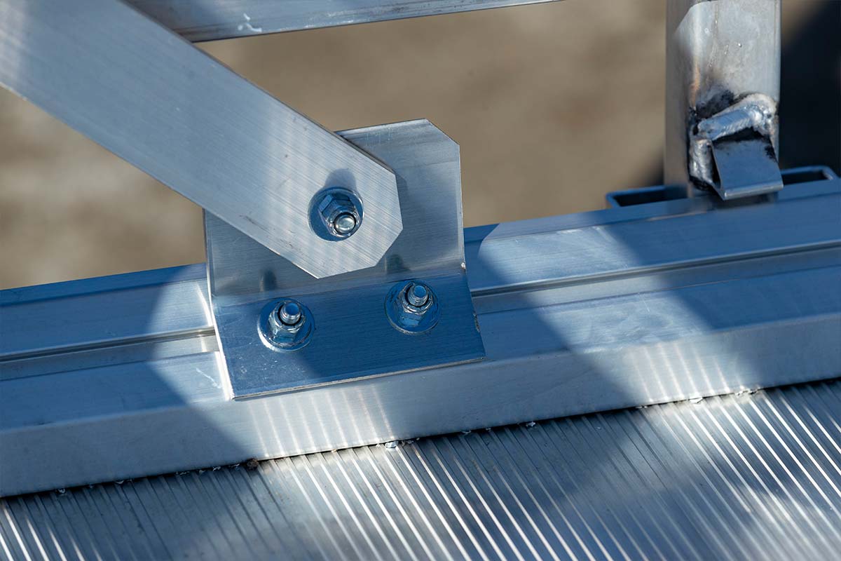 Adjustable perimeter track on open aluminum utility trailer