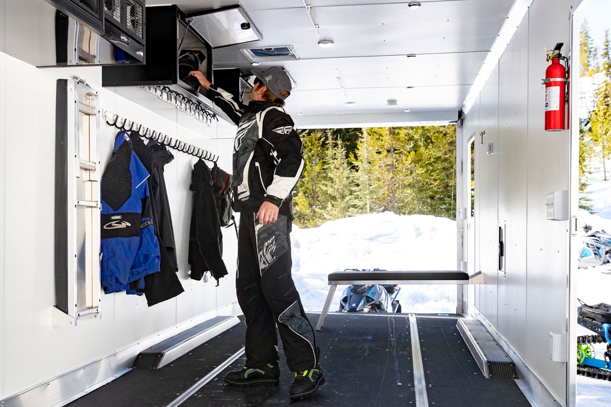 Inside an ALCOM trailer with split 96-inch overhead cabinets with pop-up doors.