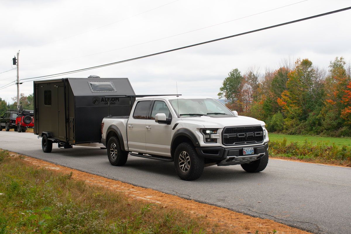 AO Trailers Caldera offroad trailer towed past by a white pickup truck