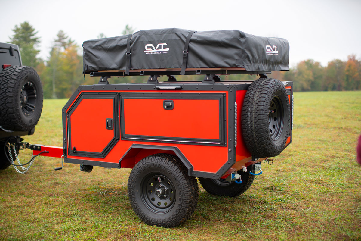 The driver's side of an AO Trailers Spur offroad trailer parked in a field