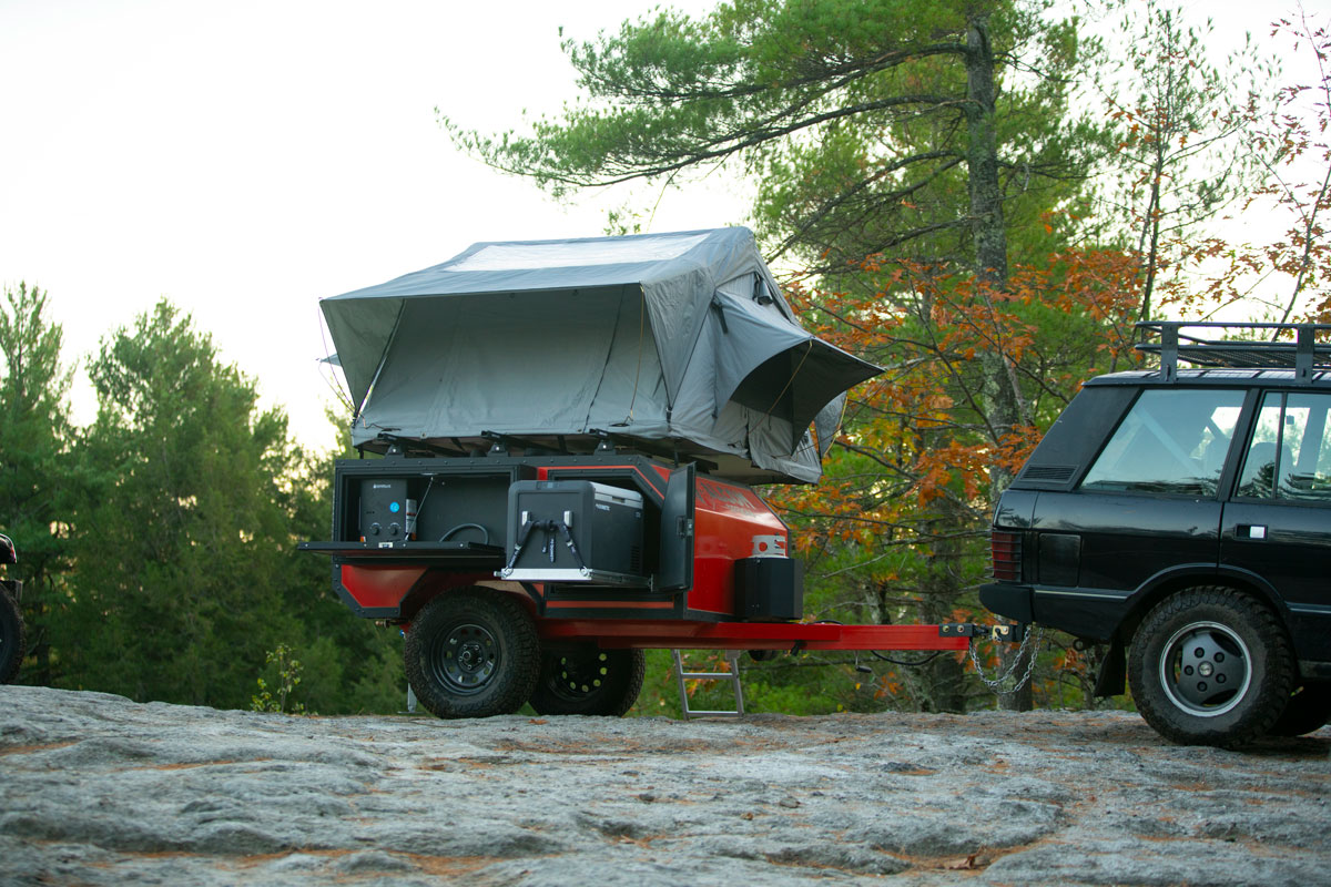 AO Trailers Spur offroad camper set up on a rocky mountaintop
