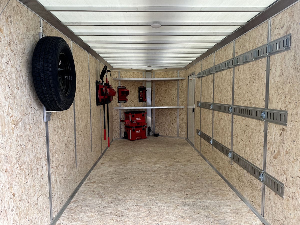 Wall tracks and tool shelves inside the aluminum trailer