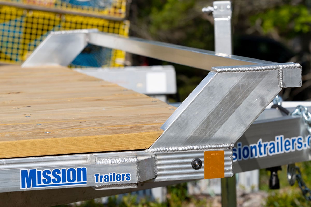 Open light duty deckover utility trailer with fixeed 2x2 front bumper rail