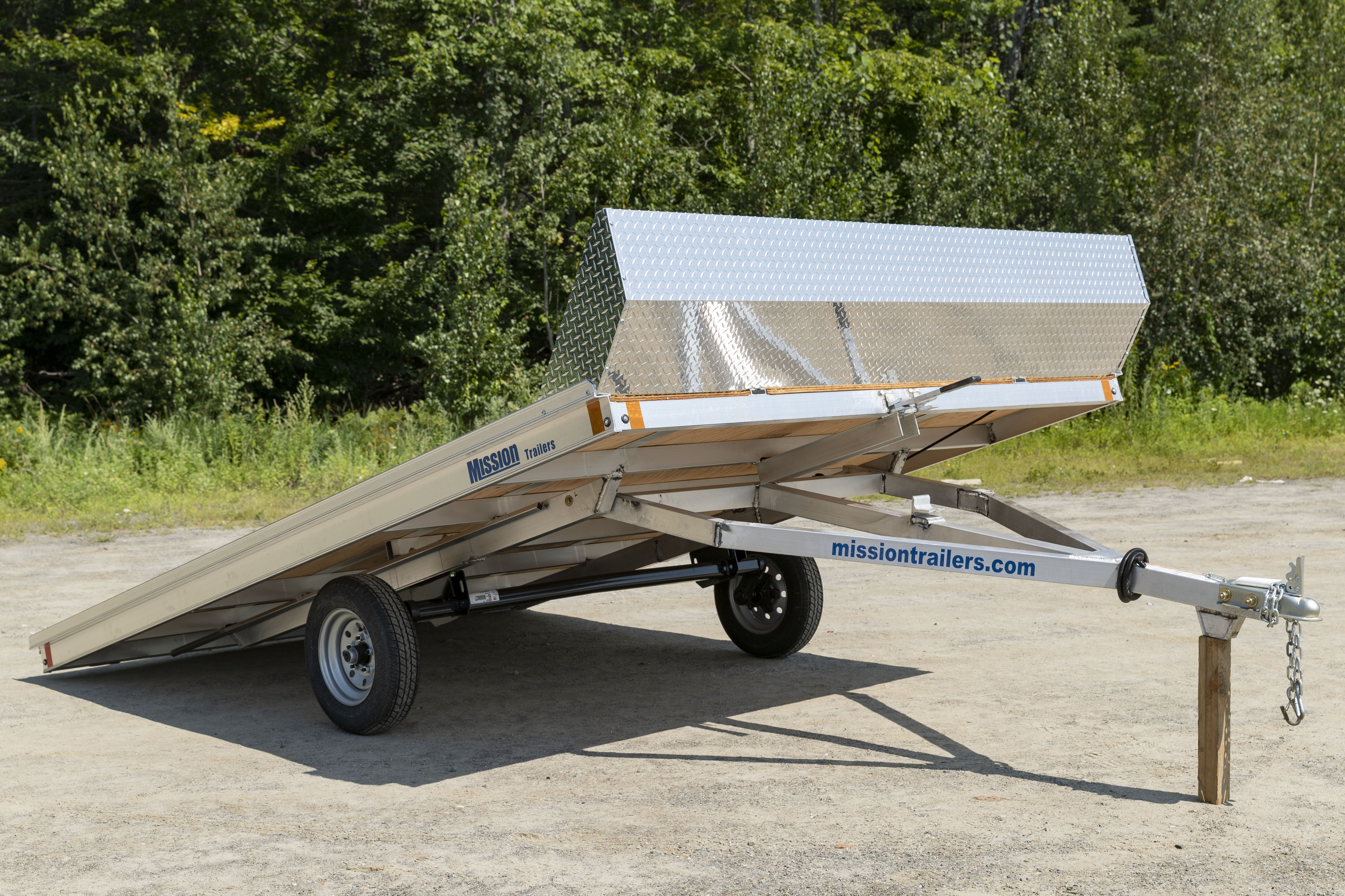 A Mission aluminum open tilting snowmobile trailer