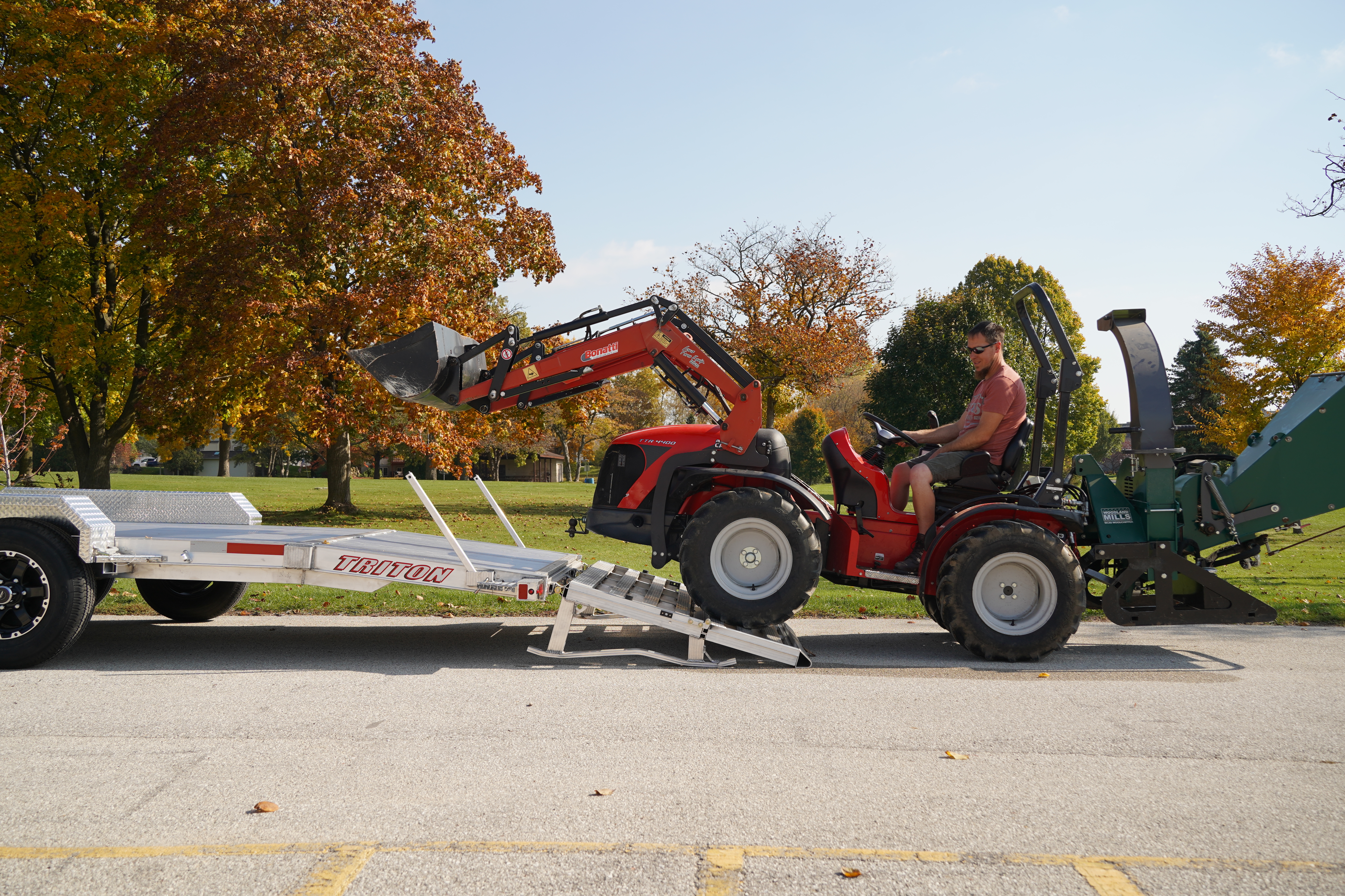 Open HD series utility trailer with beavertail and a tractor loading onto the trailer deck