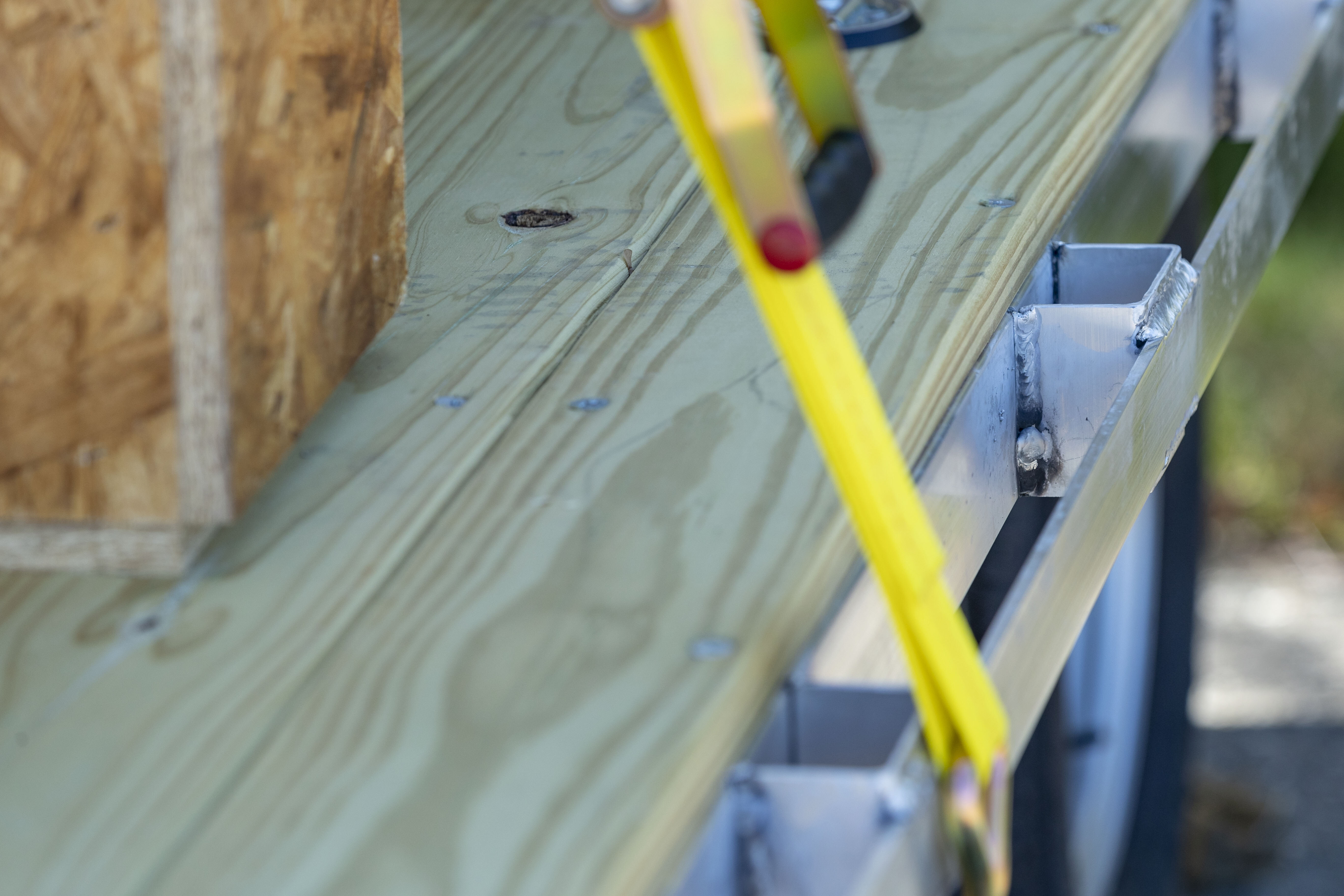 HD stake pockets and rub rail on an open aluminum utility hauler by ALCOM