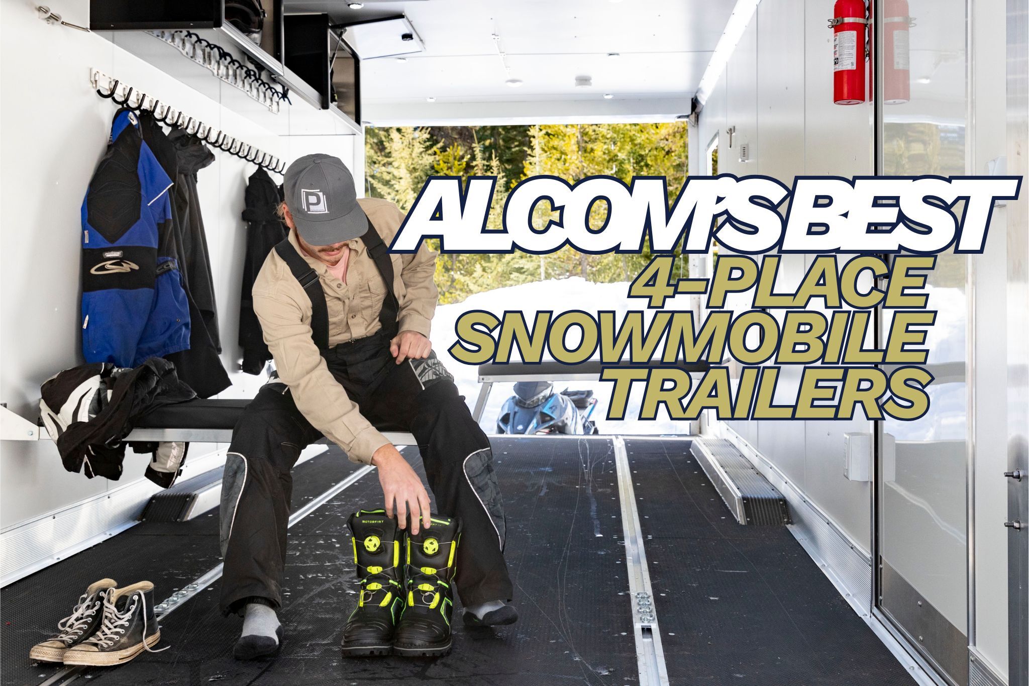 ALCOM'S best 4-place aluminum snowmobile trailers; a man getting ready to go snowmobiling in an ALCOM Elevation Series sled trailer